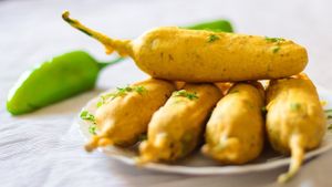Mirchi pakoda is a spicy Indian snack made of green chilies coated in a gram flour batter and deep-fried until crispy and golden brown. at Jagdish Farshan in Irving