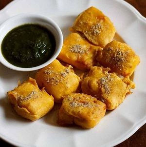 Paneer pakoda is a delicious Indian snack made by dipping cubes of paneer (Indian cottage cheese) in a spiced gram flour batter and deep-frying until crispy and golden brown. at Jagdish Farshan in Irving