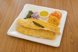 Fafda, Kadi, and Jalebi is a popular food combo from Gujarat, India, consisting of crispy chickpea flour strips (fafda) served with tangy and spicy yogurt curry (kadi) and Jalebi. at Jagdish Farshan in Irving