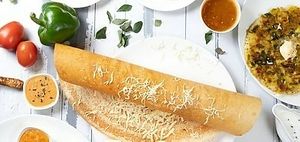 Cheese dosa is a popular South Indian dish made with a crepe-like batter of rice and lentils, filled with cheese, and served with chutney and sambar. at Jagdish Farshan in Irving