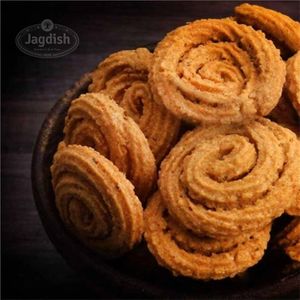 Mini chakali is a crunchy and savory snack made with a dough of rice flour and spices, shaped into spirals, and deep-fried until crispy and golden brown. at Jagdish Farshan in Irving