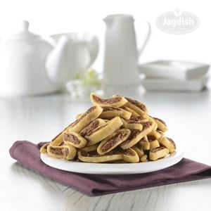 Butter bhakarwadi is made with a buttery and flaky dough, filled with a spiced mixture of mashed potatoes, coconut, and sesame seeds, and deep-fried until crispy and golden brown. at Jagdish Farshan in Irving