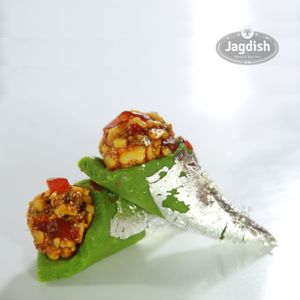 Kaju paan sweet is a mouth-watering Indian dessert made with a filling of cashew nut paste, gulkand, and various aromatic spices. at Jagdish Farshan in Irving