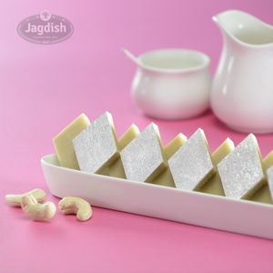 Kaju katli is a popular Indian sweet made with ground cashew nuts, sugar, and ghee, shaped into diamond-shaped pieces. at Jagdish Farshan in Irving