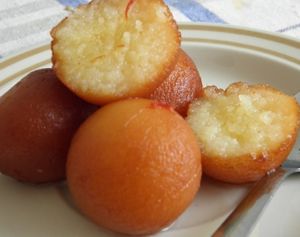 Gulab jamun is a popular Indian dessert made with milk solids, shaped into small balls, deep-fried until golden brown, and soaked in a sugar syrup. at Jagdish Farshan in Irving