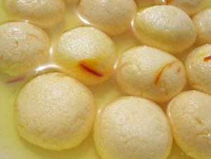 Rasgulla is a popular Bengali dessert made with spongy balls of chhena (cottage cheese) cooked in a sugar syrup flavored with cardamom or rose water. at Jagdish Farshan in Irving