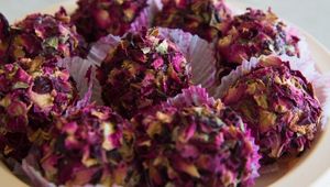 Kaju rose ladoo is a delicious Indian sweet made with ground cashews, flavored with rose water and shaped into round balls, often garnished with rose petals and chopped nuts. at Jagdish Farshan in Irving