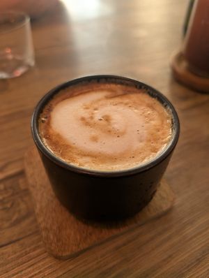 Flat white with oat milk at Comewell's in North London
