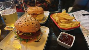 vegan burger in the front + fries  at The Harp in Hannover