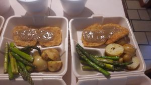 Turkey patties, gravy, roasted potatoes and seasoned asparagus at Vegan Chefcita Homemade Foods in Puerto Vallarta