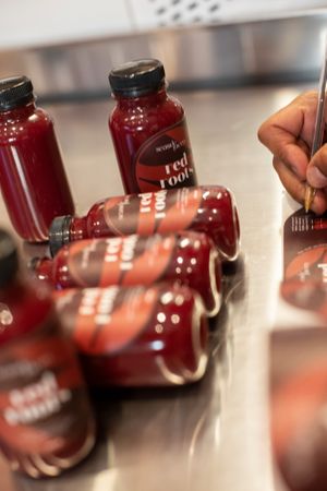 seaside juicery, monaco - making of red root cold-pressed beetroot juice at Seaside Juicery in 