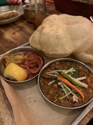 Paharganj Chana Bhatura - Deep fried leavened bread Bhatura served with spicy homemade chickpeas with achari pickled onions.   at Madam Chutney in Munich