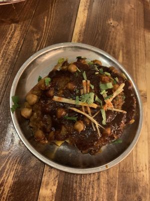 Samosa Chaat - Samosa filled with pea and potatoes with chickpea curry and yogurt on top. (Ask to remove the yogurt for a vegan dish)   at Madam Chutney in Munich