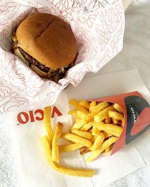 Delivered vegan truffle burger and Vicio fries. Burger contains Beyond burger, sautéed onion, sautéed shiitake, vegan black truffle based on soy milk. at Vicio in Madrid