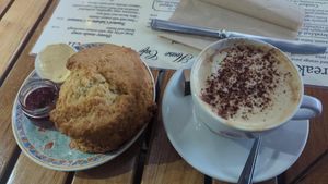 Vegan scone with vegan butter and jam. Cappuccino with oat milk. at Deacon's House Cafe in Edinburgh