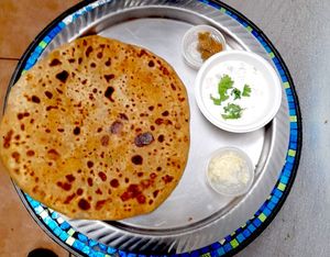 Paratha, stuffed hand made tava flatbread. DELICIOUS! Different filling options. Usually comes with yogurt sauce but you can ask for chickpeas as vegan options. Caulfilower (gobhi), Potato (aloo), radish (Mouli), and paneer (farmer's cheese). at Rasa Higher Taste in San Francisco