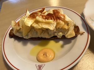 Toast with potato and smoked tofu salad, potato chips, gochujang mayonnaise, canola oil  at Lychees in Warsaw