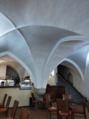 Historical arches and cozy seating at Kavárna Muzeum in Jihlava