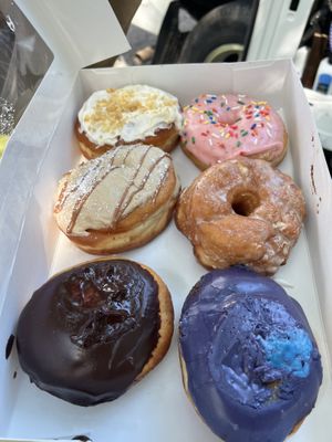 Box of donuts! Clockwise from top left: lemon crunch, strawb frosted, vanilla glaze, blueb creme, Boston creme, French toast   at Bitchin Donuts in Albany