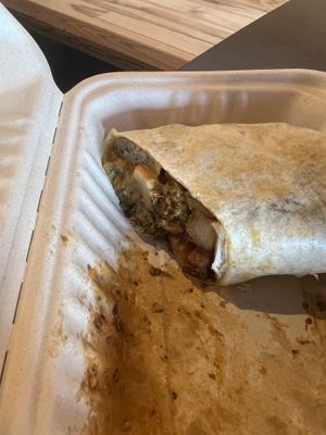 One half of a half-eaten breakfast burrito  at Bitchin Donuts in Albany