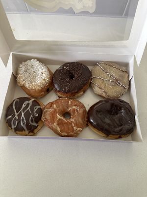 From top left to right: blueberry coffee cake, chocolate sprinkle, French toast roll. From bottom left to right: chocolate raspberry custard, maple glazed, Dubai pistachio crunch  at Bitchin Donuts in Albany