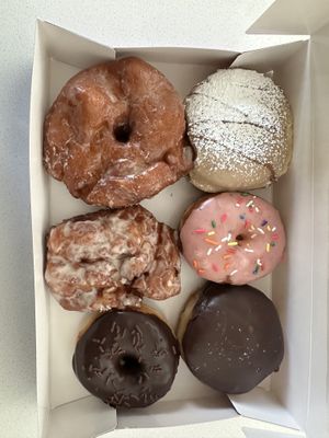 From top left clockwise: vanilla bean glaze, French toast, strawberry frosted, Boston cream, chocolate frosted, apple fritterr #Veganuary at Bitchin Donuts in Albany