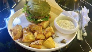 fish burger with potatoes  at PLANTS Kitchen & Bar in Almaty