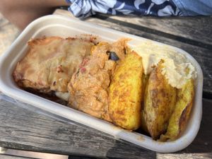 Three dish takeout box - eggplant curry, pumpkin lasagne, spiced potatoes and hummus  at Manna Haven in Byron Bay