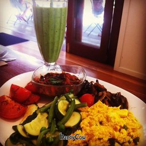 Big Brekky with scrambled tofu, garlic mushrooms, roasted tomatoes, fresh greens and beans. And a green smoothie!  at Manna Haven in Byron Bay