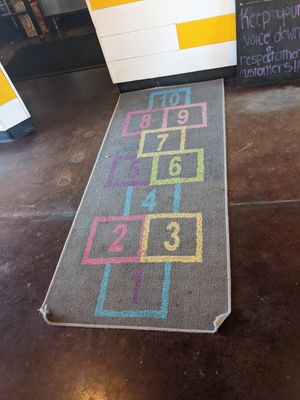 Hopscotch rug leading up to register at NUM NUM BOBA in Reno