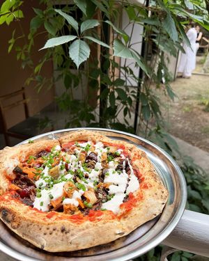 Vegan pizza with "meat" Greenwise strips, cherries and kimchi at 2022_bak in Yerevan