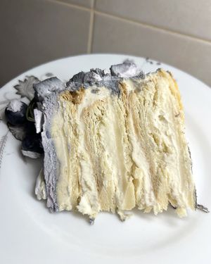 Yummy vegan Napoleon with grey creamy cover and blueberries at 2022_bak in Yerevan