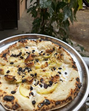 Sweet vegan pizza with juicy pears, soft "cheese" and sweet cream at 2022_bak in Yerevan