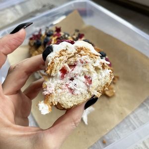 Piece of vegan croissant cake with whipped cream and sweet berries, made by Misha at 2022_bak in Yerevan