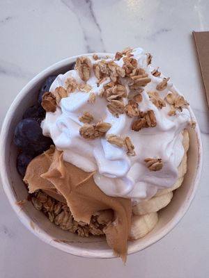 Peanut Butter and homemade jam acai bowl with blueberries, strawberries, bananas, vegan coconut ice cream and granola.   at Greens & Grains Cafe in Beaconsfield