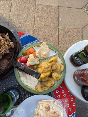 Veggies, potatoes, hummus, baba ganoush that comes with grilled meats at Vegano Mezo in Berlin