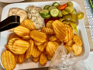 Part of the mixed grilled plate including fried potatoes, vegetables, hummus, and babaganoush/mutabal at Vegano Mezo in Berlin