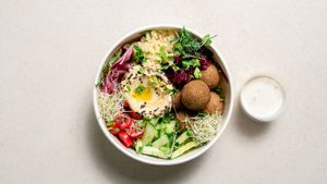 Mixed leaves salad, couscous, chickpea falafel, creamy hummus, marinated red cabbage, tomatoes, cucumbers, olives, marinated onions, black sesame seeds, parsley and microgreens. at GOVINDA in San Gwann