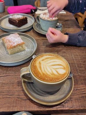 Latte, lemon drizzle, peanut butter brownie and babychino at Okapi Kitchen in Leicester
