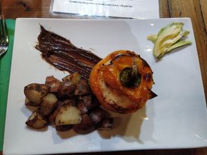 Pepper bell with vegan chorizo rice and vegetables filling with roasted potatoes at Organic Farmers Table in Sarasota