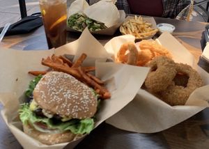 Portobello mushroom with sweet potato fries (front), onion rings (right), fries and ranch (back right), huge wrap (left). Tea was from a different establishment in the food court. at Healthy Junk in Anaheim