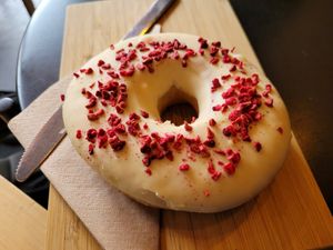 Vegan doughnut with white chocolate and dried raspberries at The Good Coffee Cartel in Glasgow