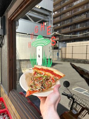 Our vegan pizza slice. Maitake mushroom, green peppers, onion and vegan cheese. at Hughes Pizza ヒューズ ピザ in Osaka