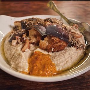 hummus with harissa, hazelnut dukkah, and cooked cauliflower & red onions on top  at VÜMO in Porto