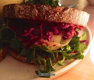 Tempeh Reuben ~ corned tempeh made in-house, caraway purple kraut, honey tahini vinaigrette, Swiss cheese, pea shoots on grilled rye.  at Heirloom in Vancouver