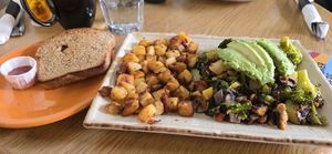Vegan Tofu Scramble with added avocado, potatoes, homemade wholewheat toast at Rainbow Restaurant in Fort Collins