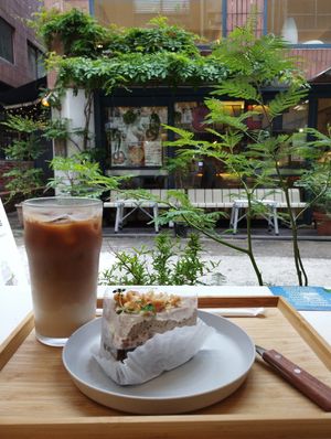 Earl Grey and chocolate cake with an iced soy latte, right at the window seat at Moonggoojeom Vegan Bakery in Busan