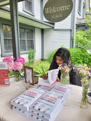 Dr. Anne signing books at her Book Launch Fundraiser to support menstrual equity and Moon Time Connections on June 8, 2024. at Dr. Anne Hussain, ND in East Gwillimbury