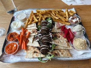Falafel plate with dips, hummus, pita, french fries at Koshary Corner in Baltimore