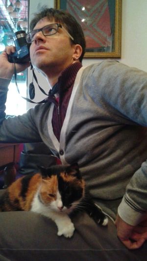 Resident kitty Zillion resting on a contented customer's belly. at Rumist in Istanbul